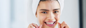Closeup Young Woman Flossing Teeth