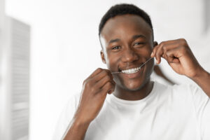 Man flossing gingivitis prevention concept