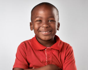 Happy child smiling in red shirt