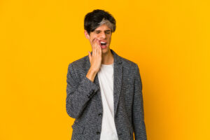Man having molar pain on yellow background