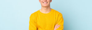 Teen in yellow shirt on blue background