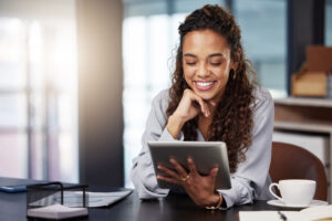 Woman smiling looking at tablet