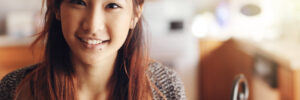 happy smiling asian teen girl portrait in kitchen