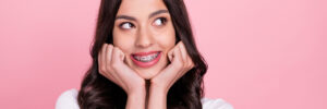 Photo of adorable happy young woman wearing braces